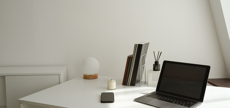 Office setup with a laptop on table along with peaceful environment- perfect for work- WFH- work from hone
