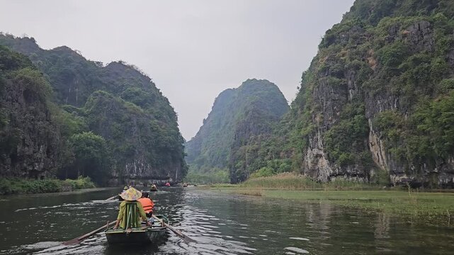Canoeing Through Scenic Limestone Mountains in Ninh Binh, Vietnamcanoe on river