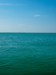 Obraz premium Photography tranquil seascape with calm sea ocean waters stretching to the horizon under a clear blue sky, evoking peace and openness.relaxing summer scene perfect for travel holliday and nature lover