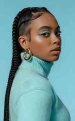 a woman with braided hair wearing turquoise makeup and sweater