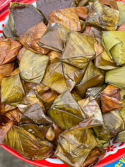 Thai dessert mixed with glutinous rice flour, green beans, salt and pepper wrapped in banana leaves and steamed (Khoaw nom tien)