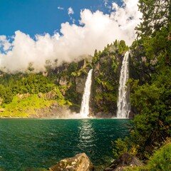 Alpine lake with cascading waterfalls