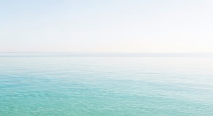 Obraz premium Serene Seascape: Pale Sky Meets Tranquil Teal Waters