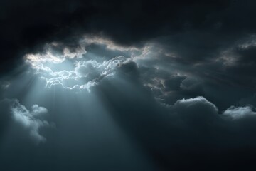 Dramatic sky with sunbeams piercing through dark clouds
