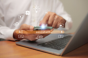 Businessman using smartphone with AI assistant icons and laptop on wooden desk, representing artificial intelligence technology, digital innovation, and modern business solutions.