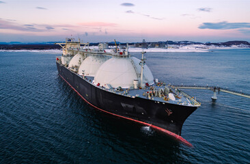 Aerial of Liquified Natural Gas LNG carrier moored to a small gas terminal. Fuel crisis. Sanctions