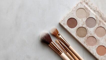 Makeup brushes and palette on marble