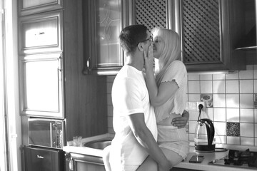 Lovely family enjoying breakfast together at their apartment. Spend Time With Significant Other. Cute family drinking coffee sitting in kitchen, looking at each other with love