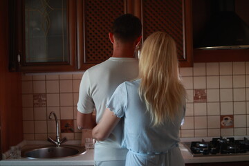Lovely family enjoying breakfast together at their apartment. Spend Time With Significant Other. Cute family drinking coffee sitting in kitchen, looking at each other with love