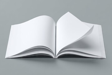 A pristine, blank, square-format book lies open on a neutral gray background, its pages gently curled at the edges, suggesting a soft breeze or recent turning