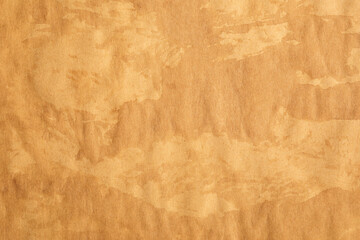 Old crumpled parchment paper with rustic stains