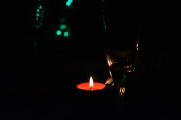 Red burning candle on dark background
