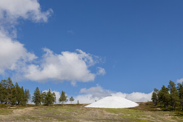 Snow preserved under plastic cover in ski slope in summer