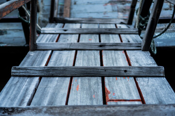 Old plank bridge to a boat.