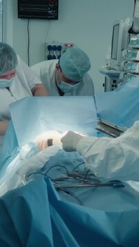 Nurse gathers steel tools in surgery room. Cardiological surgeons take care after coronary artery bypass surgery with in hospital. Dangerous operation
