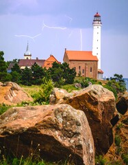 Coastal town with lighthouse and storm
