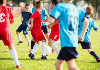 Boys kicking football on the sports field