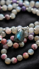 Mala beads made of labradorite, charoite and pink tourmaline with a labradorite pendant. High quality photo
