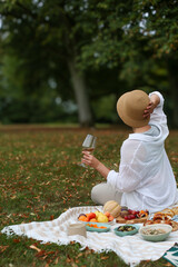 Woman Relaxing Outdoor Picnic Wine and Fresh Fruits