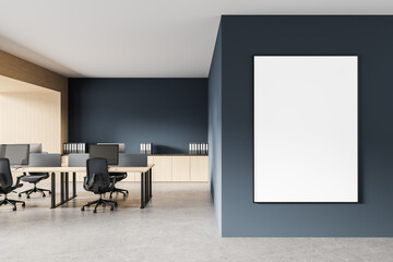 Modern open-plan office interior with blank vertical poster mockup on dark blue wall, minimalist design and wooden elements throughout the space. 3D Rendering