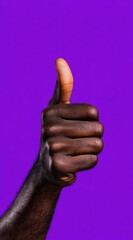 A dark-skinned hand with thumb extended upward, signifying approval or positivity, contrasted against a vivid purple background