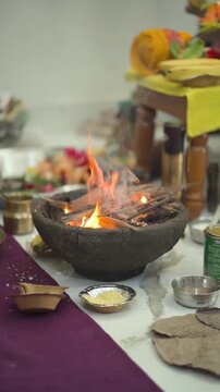 Traditional havan ritual with fire, Hindu puja offering flames, Spiritual ceremony with sacred fire, Hand offering in religious ritual stock video. 