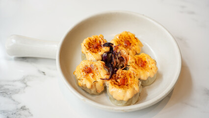 Dimsum with Japanese Mentai Sauce. Served on plate.