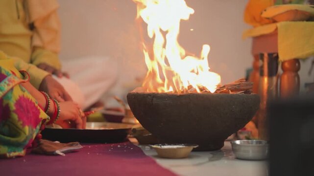 Sacred fire ritual at home, Hindu puja ceremony with havan, Spiritual worship with holy fire, Traditional Indian religious ritual stock video. 