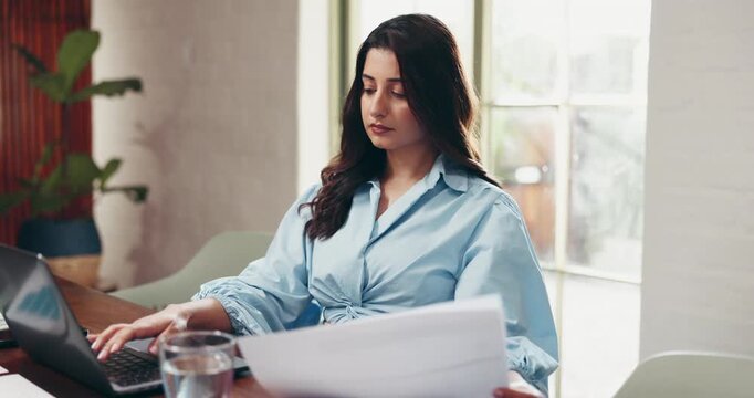 Typing, woman and employee with laptop in office, serious or account manager with documents or info. Data entry, bookkeeping and person with tech for financial report, paperwork and asset management
