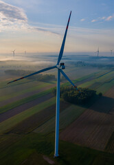 Aerial view of a windmill  on a foggy autumn day.