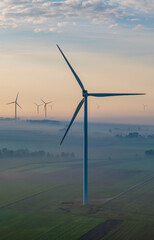 Aerial view of a windmill  on a foggy autumn day.