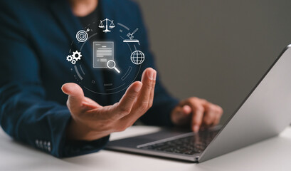 A person using a laptop displays digital icons representing technology, data, and communication in a professional setting.
