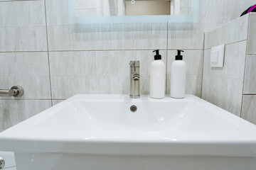 Introducing a modern bathroom sink that features stylish bottles with a sleek design, enhancing the ambiance and elegance of your space while combining cleanliness and functionality
