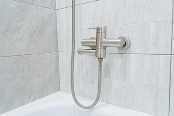 Experience the elegance of a modern shower faucet featuring a stylish handheld showerhead,...