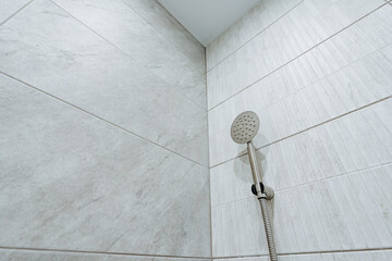 Discover a modern shower space with elegant tile and a luxurious rainfall showerhead, transforming...