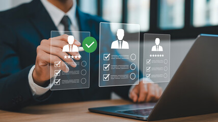 Businessman reviewing candidate profiles on holographic interface with checkmarks and stars hiring recruitment