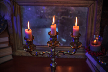 Candles burns on the altar, magic among candles, clean negative energy, wicca concept	