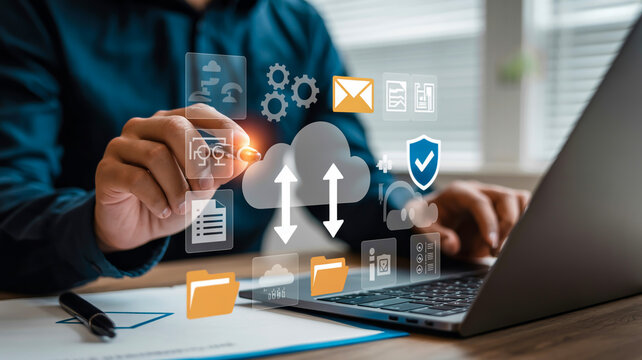 Person using laptop with cloud computing and data transfer icons on holographic display storage upload