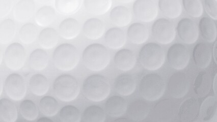 Extreme macro detail of a white golf ball surface, showcasing the iconic dimple pattern as an abstract textured background for sports concepts