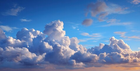 Vast, cumulus clouds against a vibrant blue sky.  Soft, pastel hues paint the clouds and sky
