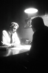 Detective interrogates suspect in police station under dim light during a crime investigation