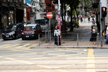View landscape building skyscraper cityscape house of HongKong city and life lifestyle local chinese people walking on street with traffic light at traffic road on April 26, 2025 in Hong Kong, China