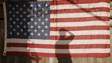 Shadow of a person saluting in front of an American flag