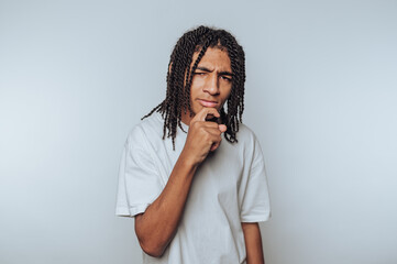 portrait of young man displays a curious expression, symbolizing contemplation and thoughtfulness...
