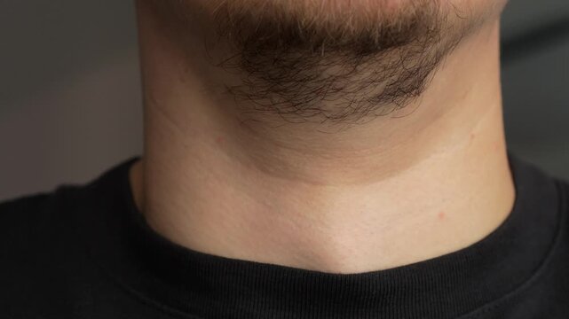 Adam's apple on a male body.
Movement of the Adam's apple during swallowing.
Male body parts and sexual differences.
Adam's apple on the throat of an adult bearded man