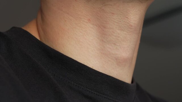 Male kazhik on a man's throat.
A man takes a slurp close-up.
A man swallows something and the movement of the Adam's apple and throat on the neck close-up