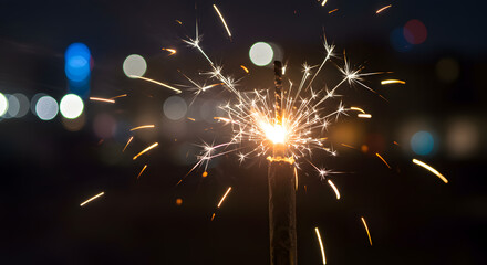 Obraz premium Burning sparkler with a bokeh light for a diwali new year or a party