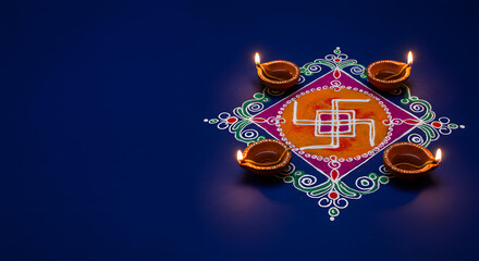 Traditional swastika rangoli with a diya lamp for a diwali festival puja celebration design