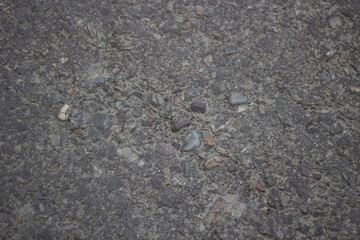 Closeup texture of asphalt with small pebbles and aggregate