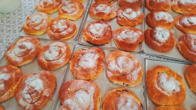 Traditional Majorcan ensaimadas pastries dusted with sugar at Palma market